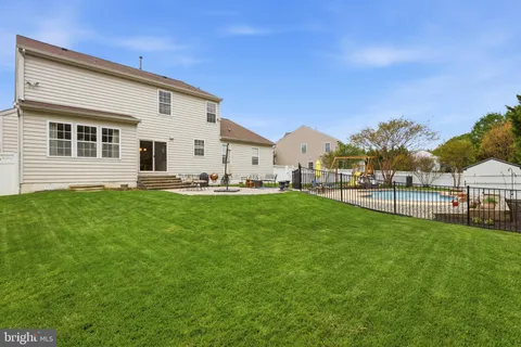 a front view of a house with yard and green space