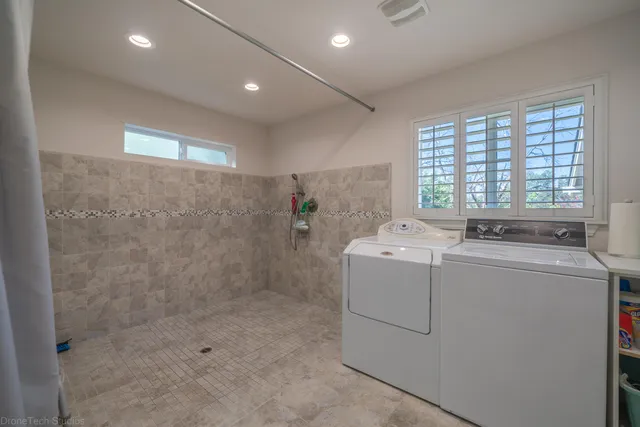 a view of bathroom with a washer and dryer