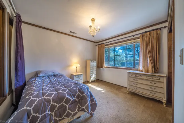 a bedroom with a bed and a window