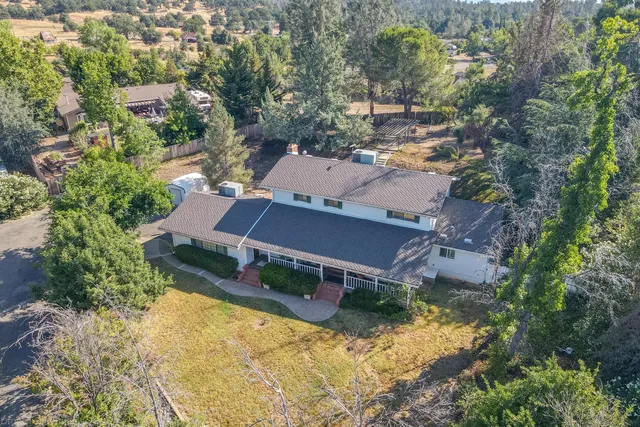 an aerial view of a house with yard swimming pool and outdoor seating
