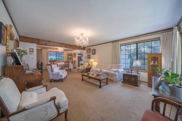 a living room with furniture and a chandelier