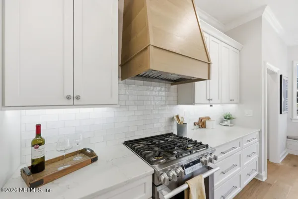 a kitchen with stainless steel appliances granite countertop a sink stove and cabinets