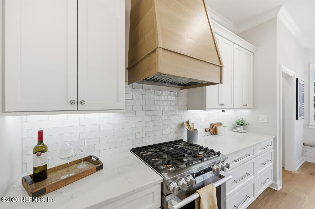 7956 Hollyridge Road Jacksonville, FL 32256 - Photo 13 of 50 a kitchen with stainless steel appliances granite countertop a sink stove and cabinets