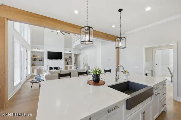 a kitchen with sink a microwave and cabinets