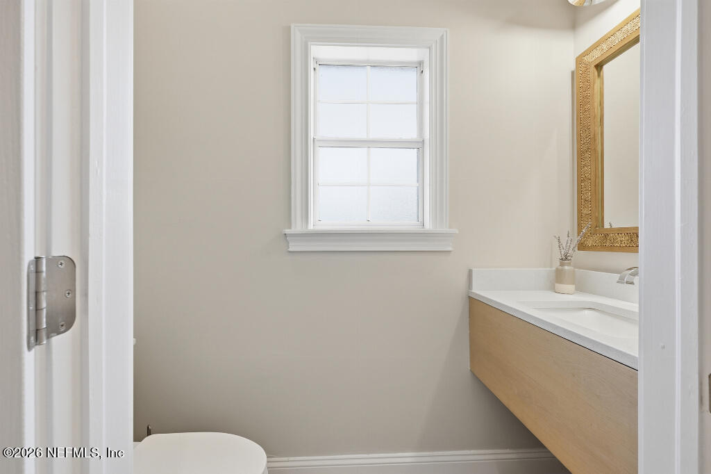 7956 Hollyridge Road Jacksonville, FL 32256 - Photo 18 of 50 a bathroom with a sink a toilet and a window
