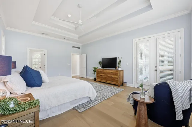 a bedroom with a bed a couch and a flat screen tv