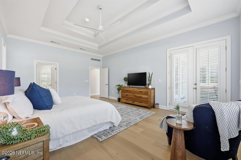 7956 Hollyridge Road Jacksonville, FL 32256 - Photo 21 of 50 a bedroom with a bed a couch and a flat screen tv