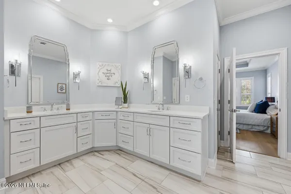 a spacious bathroom with a granite countertop sink a mirror a vanity and a