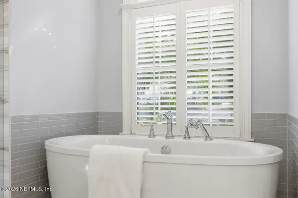 a bathroom with a bathtub and a window
