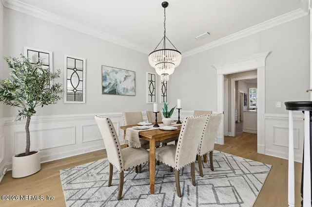 a view of a dining room with furniture and wooden floor