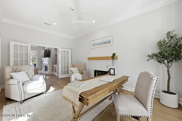a living room with furniture a table and a potted plant