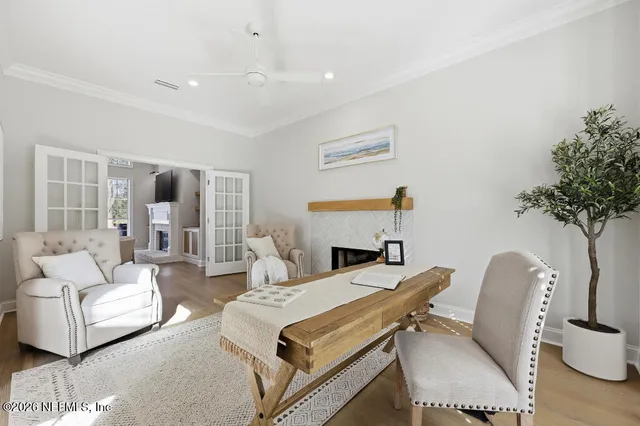a living room with furniture a table and a potted plant
