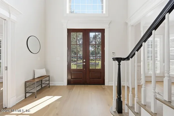 a front view of a house with wooden floor and windows