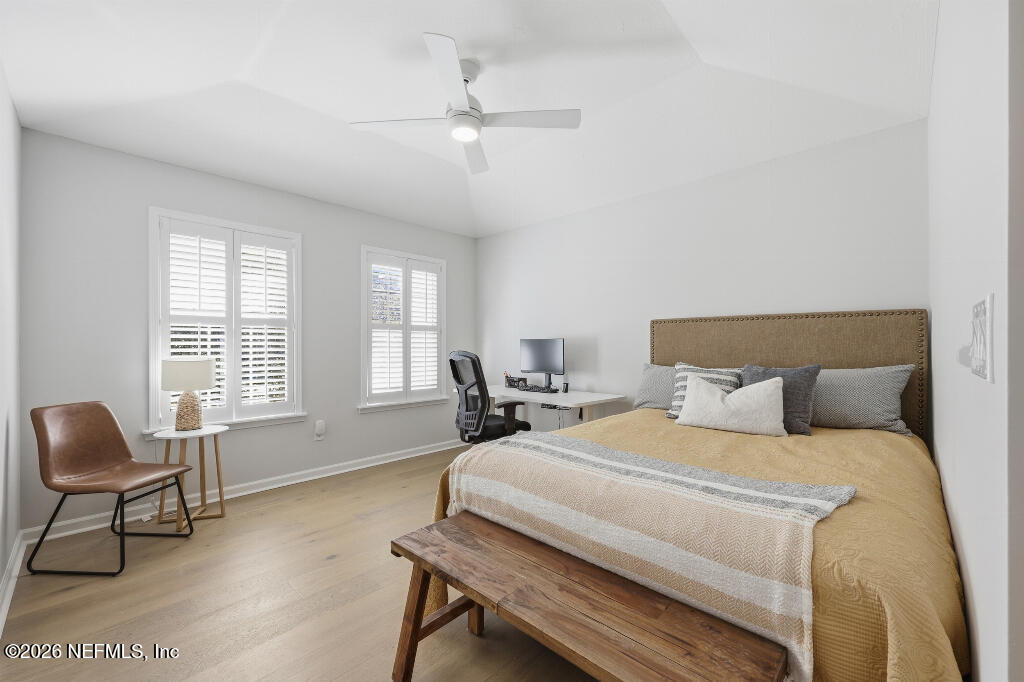 7956 Hollyridge Road Jacksonville, FL 32256 - Photo 34 of 50 a bedroom with a bed and a chandelier