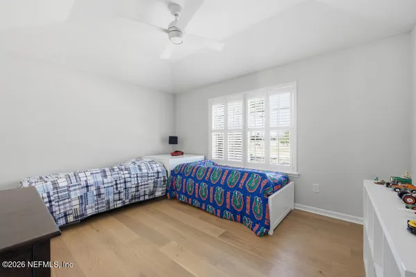 a room with with baby crib and a couch