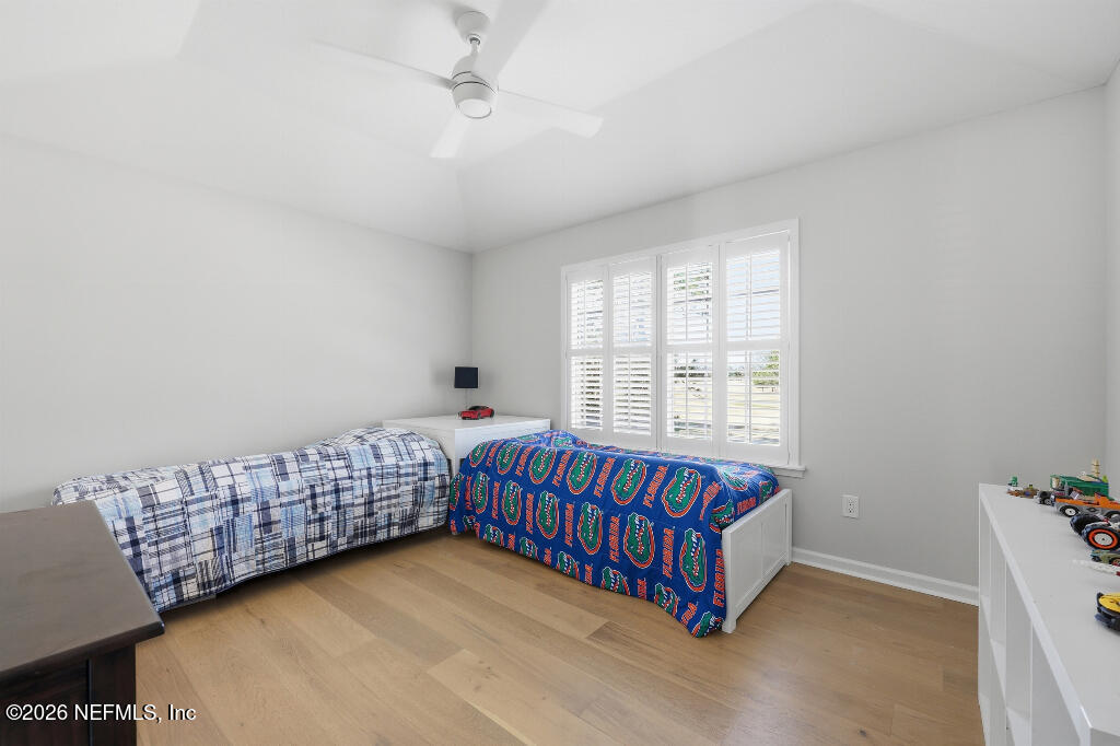 7956 Hollyridge Road Jacksonville, FL 32256 - Photo 36 of 50 a room with with baby crib and a couch