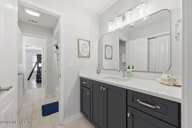 a bathroom with a sink a vanity and a mirror