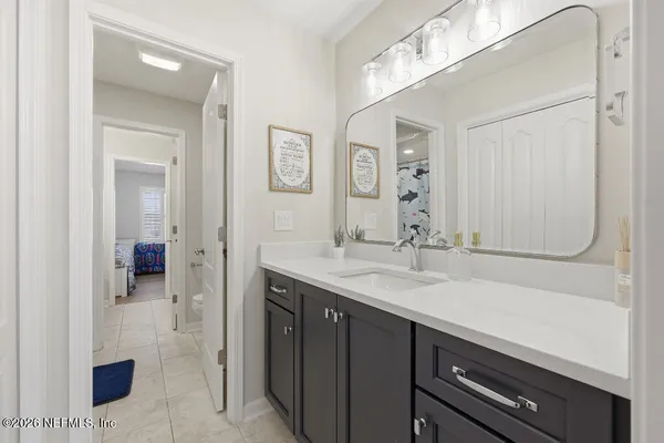 a en suite bathroom with a sink double vanity and a mirror