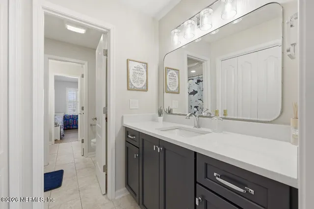 a en suite bathroom with a sink double vanity and a mirror