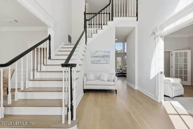 a view of entryway and hall with wooden floor