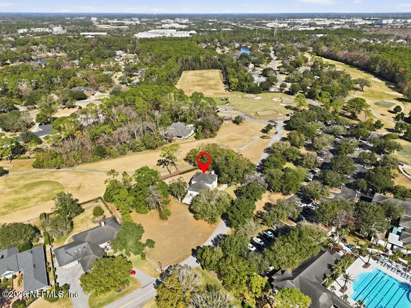 an aerial view of residential houses with outdoor space
