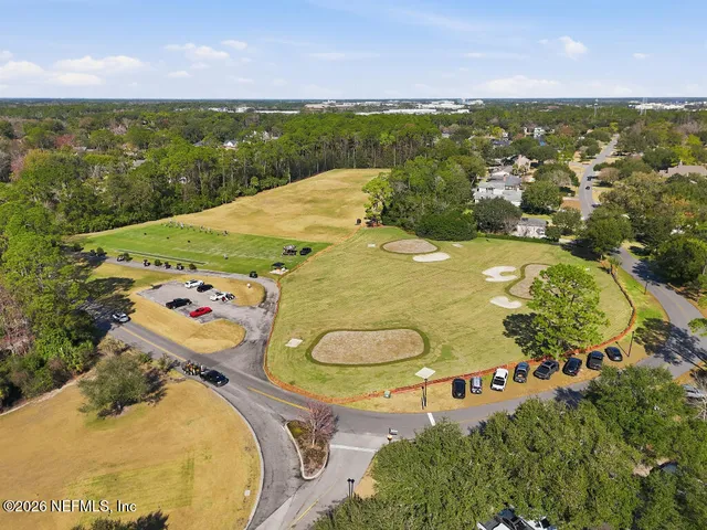 an aerial view of a swimming pool with a yard