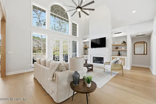a living room with furniture a fireplace and a flat screen tv