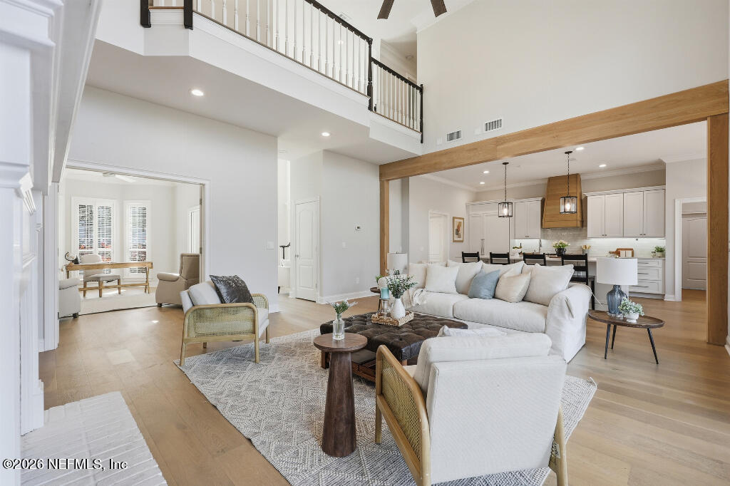 7956 Hollyridge Road Jacksonville, FL 32256 - Photo 9 of 50 a living room with furniture kitchen view and a wooden floor