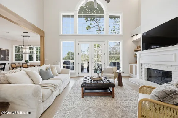 a living room with furniture fireplace and flat screen tv