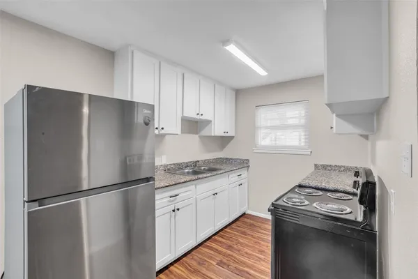 a kitchen with a refrigerator stove and sink