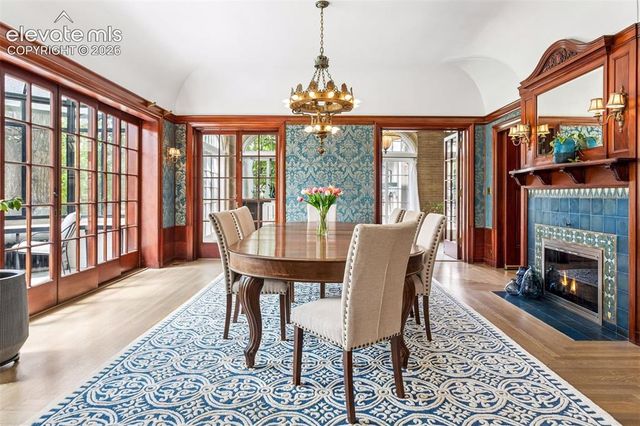 a view of a dining room with furniture a chandelier and wooden floor