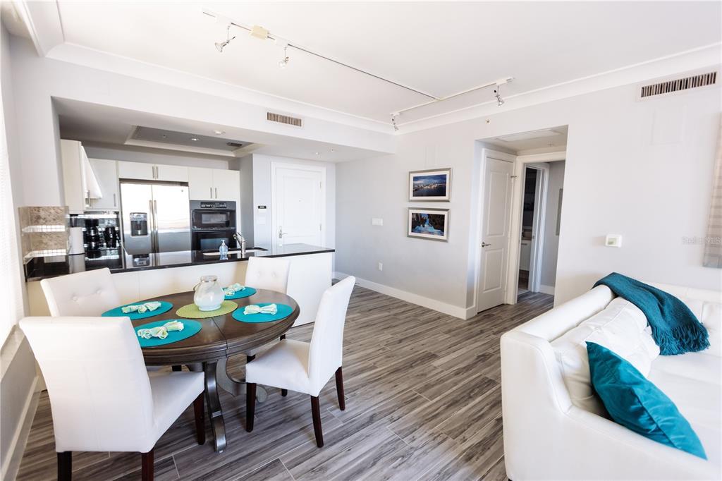 1350 Main Street, Unit 709 Sarasota, FL 34236 - Photo 18 of 56 a view of a dining room with furniture and wooden floor
