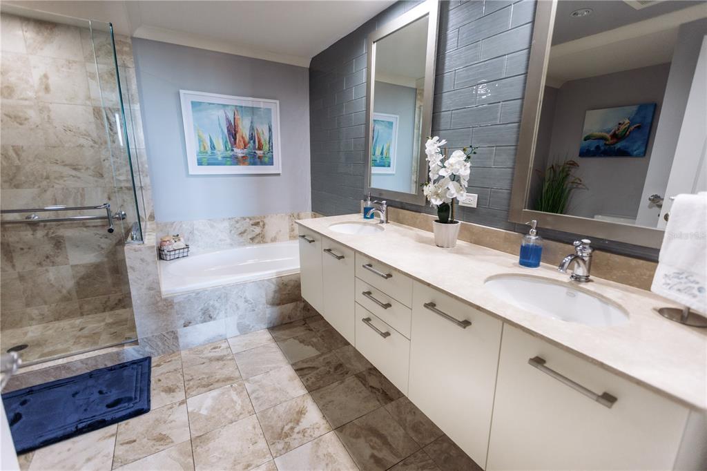 1350 Main Street, Unit 709 Sarasota, FL 34236 - Photo 22 of 56 a bathroom with a double vanity sink a mirror and a bathtub
