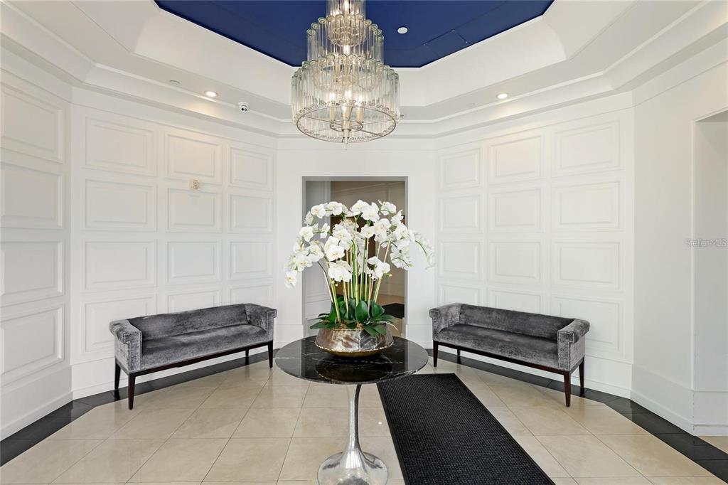 1350 Main Street, Unit 709 Sarasota, FL 34236 - Photo 26 of 56 a living room with furniture and a chandelier