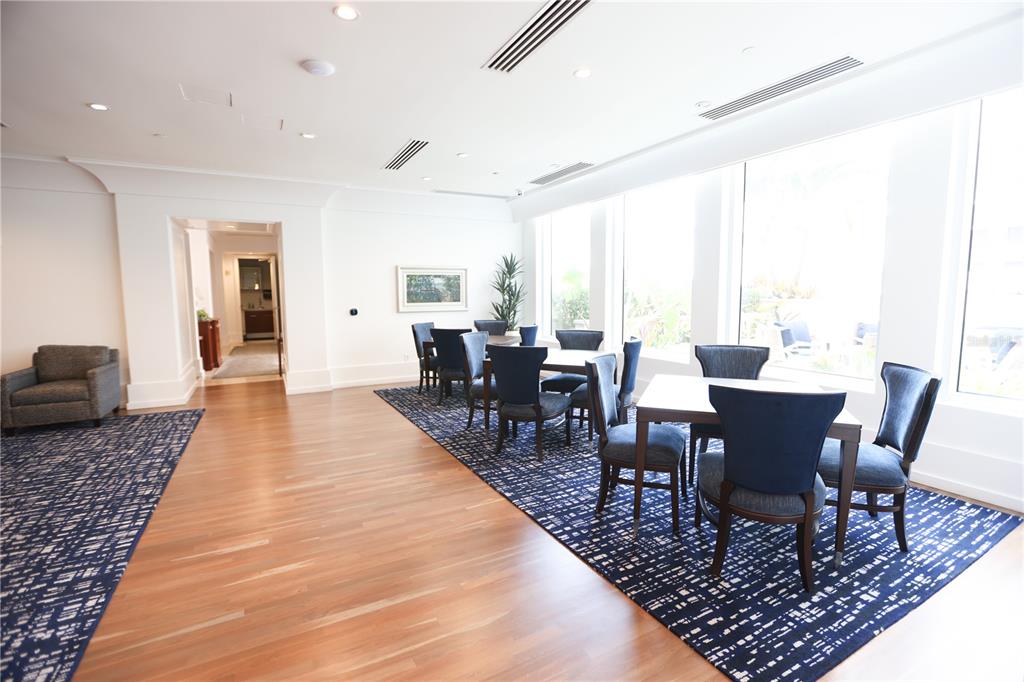 1350 Main Street, Unit 709 Sarasota, FL 34236 - Photo 32 of 56 a dining room with wooden floor a large window and a rug
