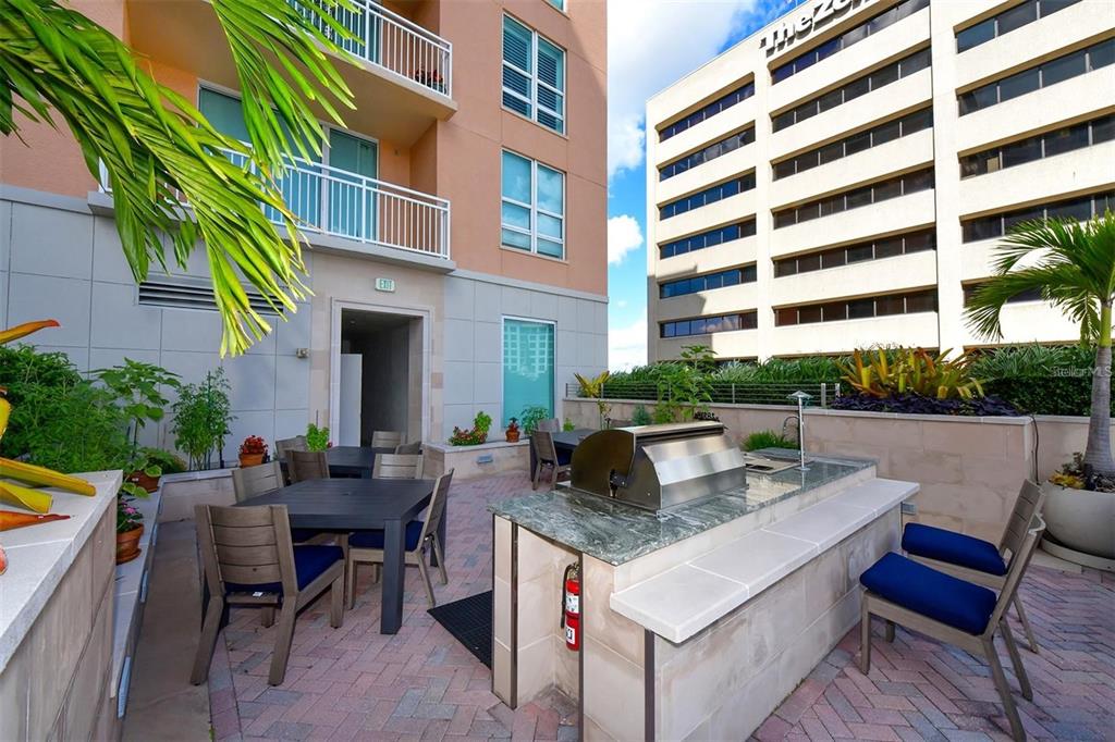 1350 Main Street, Unit 709 Sarasota, FL 34236 - Photo 36 of 56 a view of dinning table and chairs in patio