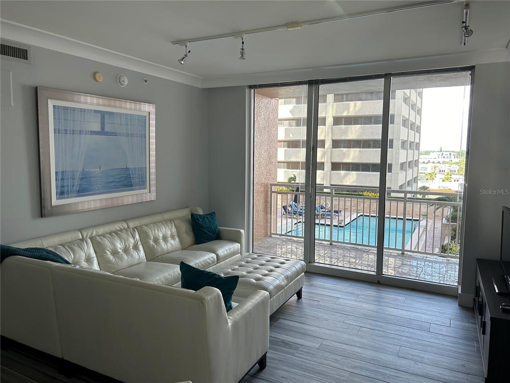 1350 Main Street, Unit 709 Sarasota, FL 34236 - Photo 5 of 56 a living room with furniture and wooden floor