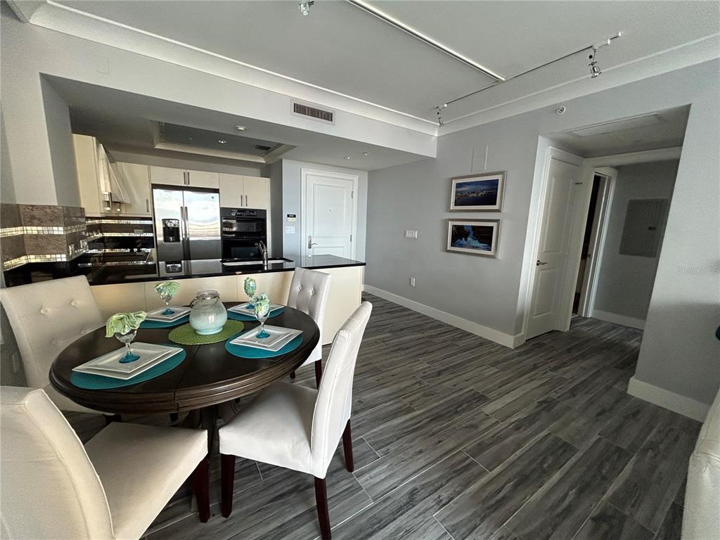 1350 Main Street, Unit 709 Sarasota, FL 34236 - Photo 9 of 56 a dining room with furniture and wooden floor
