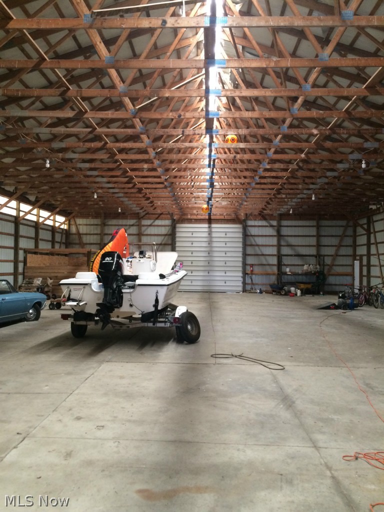 3463 Lester Road Medina, OH 44256 - Photo 7 of 24 60x104 (6,240 Sq. Ft.) Steel out building w/fully concreted floor with 14' doors on end and east side of building. Building includes 220-v electrical line and water. There are 2 12x12 stalls located at one corner of the building and separated finished office space with attic storage at opposite end.