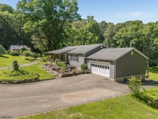 a view of a house with a garden and pathway