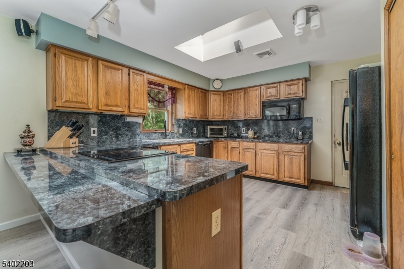 20 South Polktown Road Hampton, NJ 08827 - Photo 16 of 44 a kitchen with stainless steel appliances granite countertop a sink a stove and a wooden floors