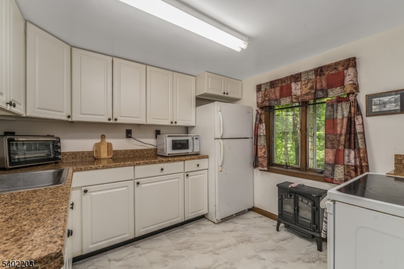 20 South Polktown Road Hampton, NJ 08827 - Photo 19 of 44 a kitchen with a refrigerator a stove a sink and a cabinets