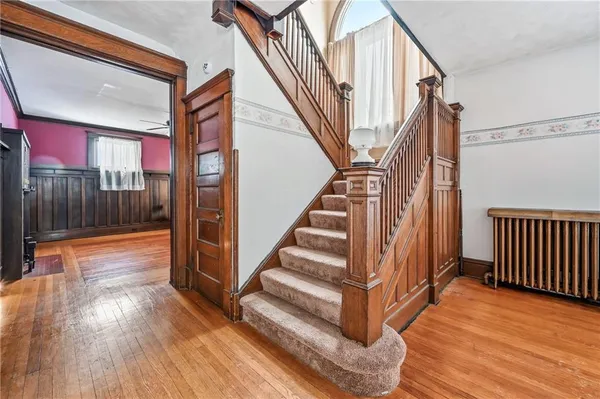 a view of entryway and hall with wooden floor