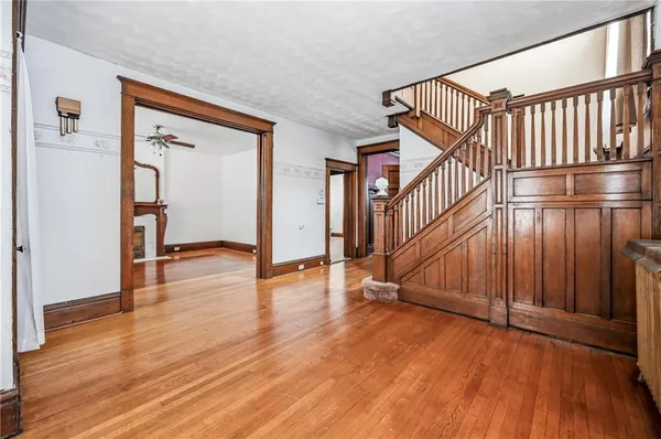 a view of an entryway with wooden floor and door