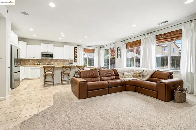 a kitchen with a table chairs sink and cabinets