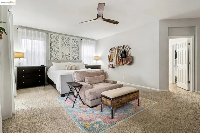 a bedroom with a bed a flat screen tv and a fireplace