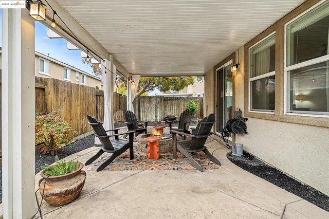 a view of a patio with table and chairs and potted plants