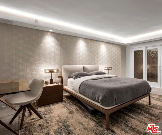 a bedroom with a bed and lamp