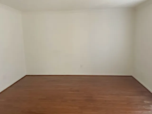 an empty room with a empty space and windows
