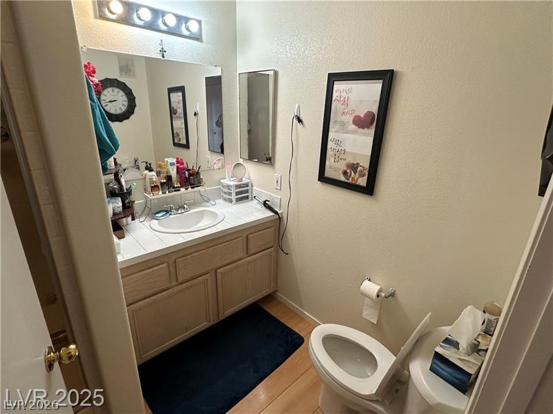 1830 North Pecos Road, Unit 230 Las Vegas, NV 89115 - Photo 11 of 16 Functional vanity and bright overhead lighting define this well-appointed bathroom space.